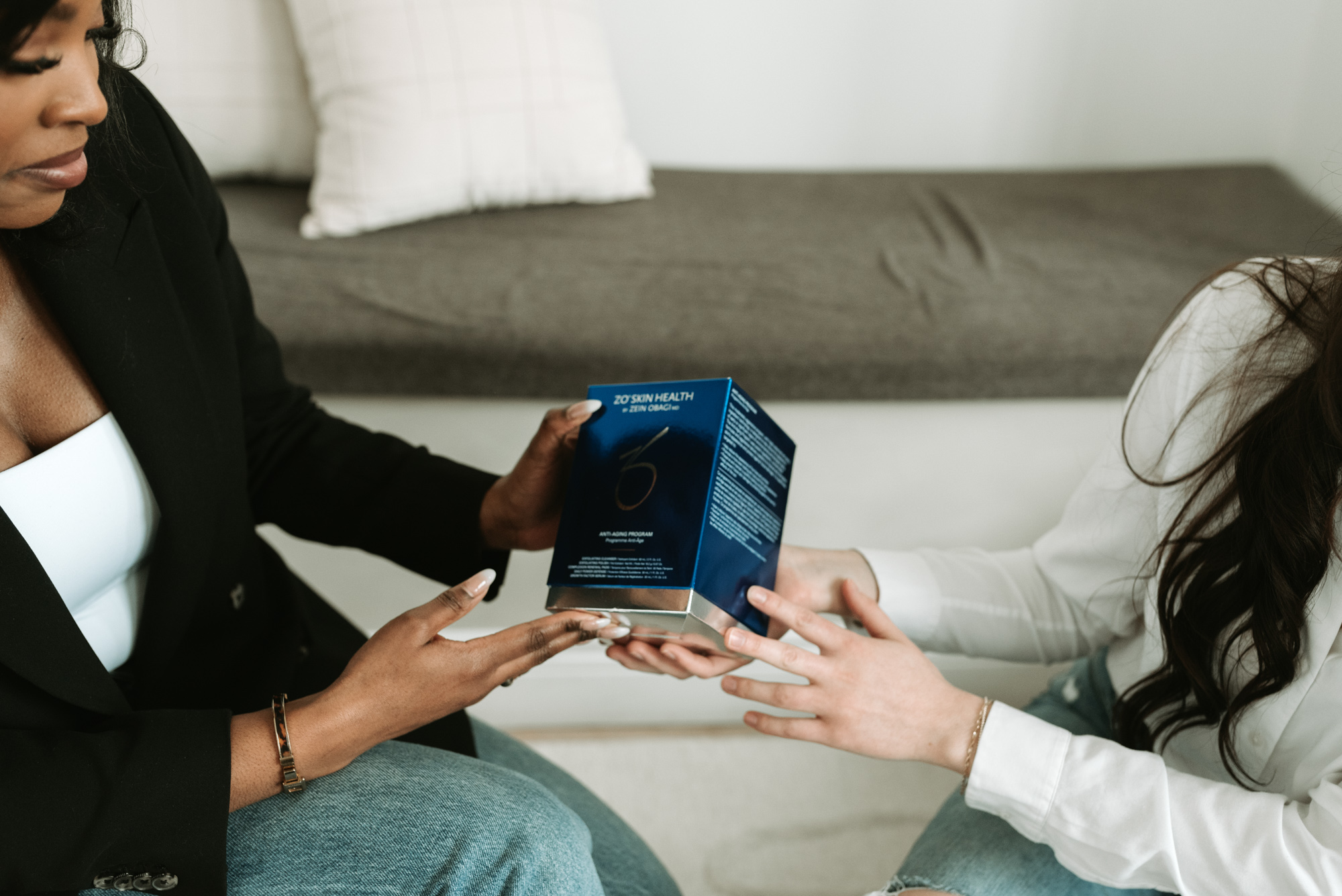 A Worthy provider hands a patient a medical-grade skincare product she can use to complement the results of her PRP treatment near Kitchener.