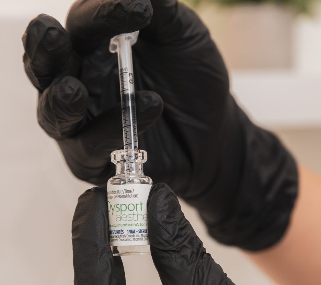 A provider prepares a syringe of neurotoxin for treatment with Botox near Kitchener.