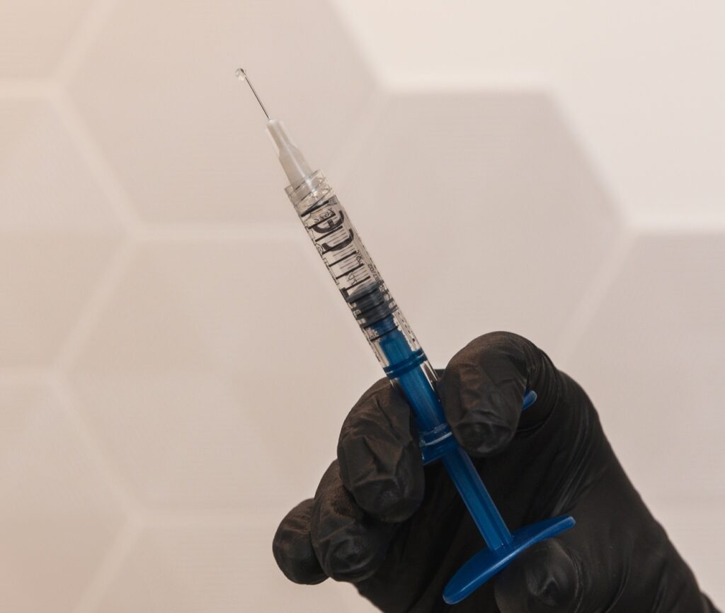 A provider prepares a syringe with dermal filler for cheek filler near Kitchener.