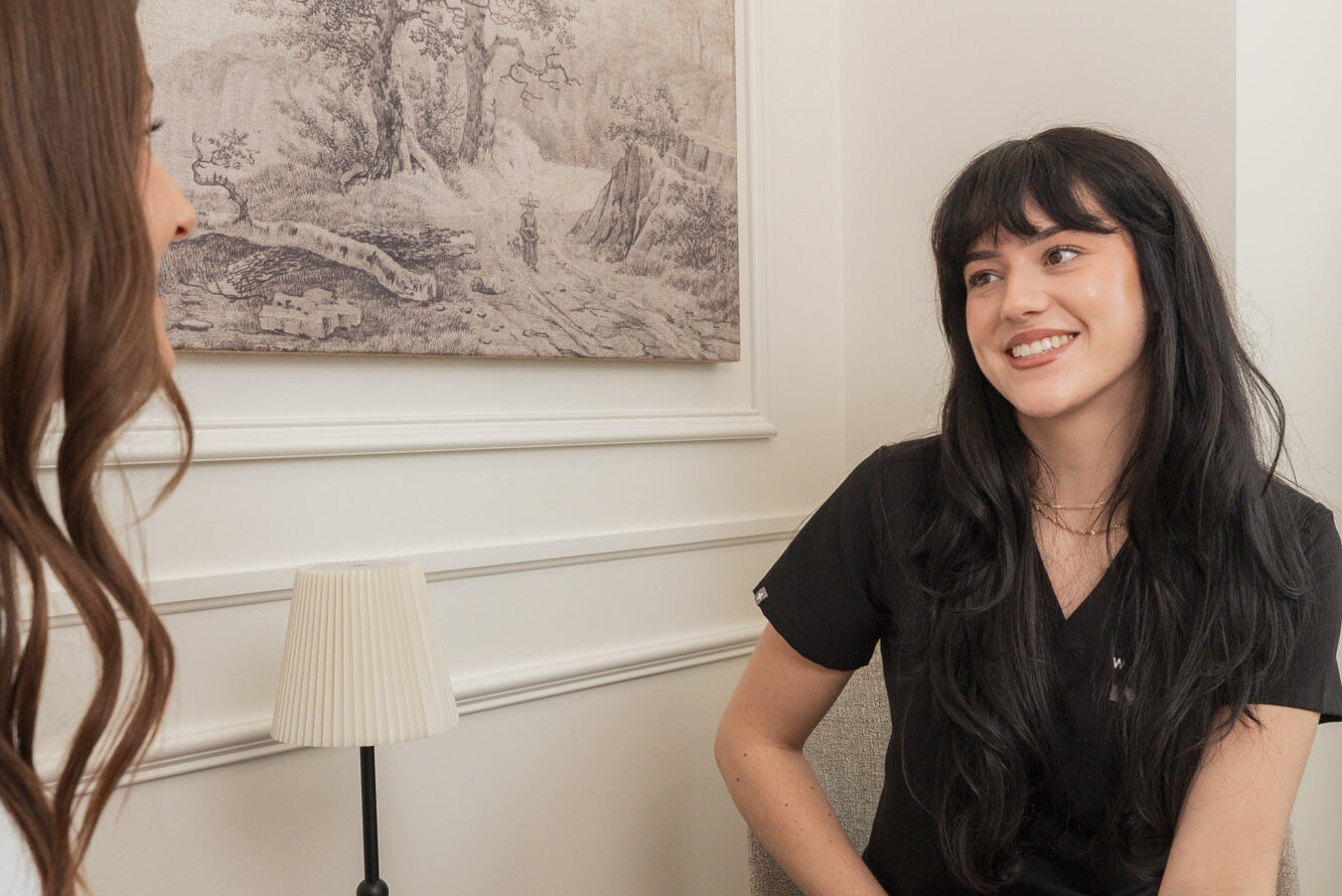 A patient consults with a Worthy aesthetician to discuss microneedling near Waterloo, Ontario.